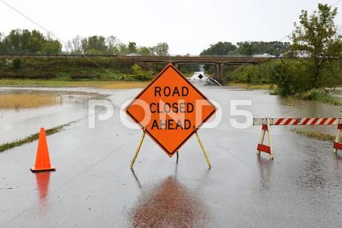 Road Closed Ahead Sign Over Rain Flooded Street Stock Photos