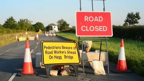 Road closed and warning sign of construction workers ahead united kingdom Stock Footage 154455825