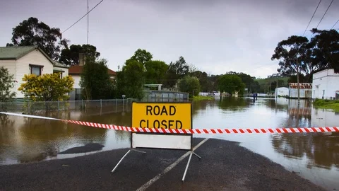 Road closed sign blocking flooded street in Casterton, Victoria. Stock Footage 93264359