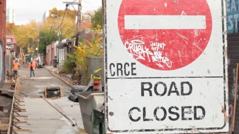 Road closed sign with construction workers Stock Footage 69186324