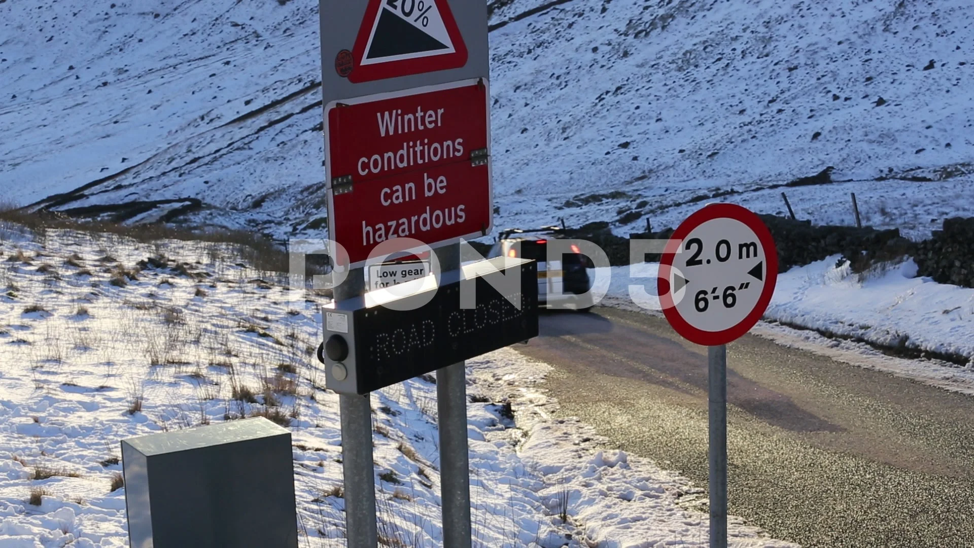 A road closed sign on Kirkstone Pass in the Lake District UK after the road