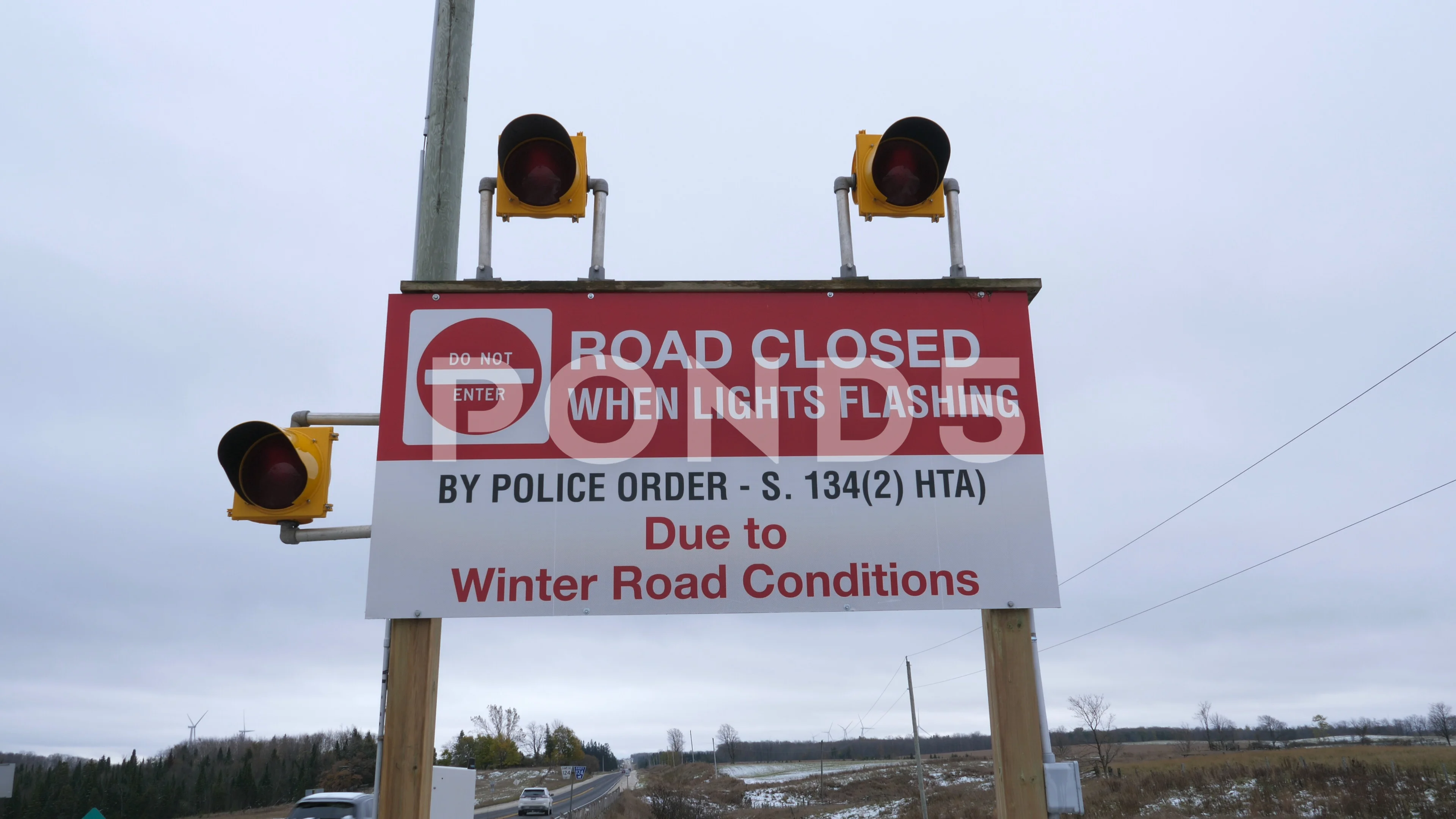 Road closed when lights flashing. Sign to warn drivers of Winter road closure