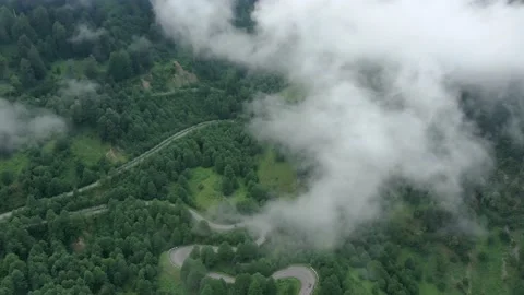 Road in clouds, View from drone above clouds of mountain village. Stock Footage 236921907