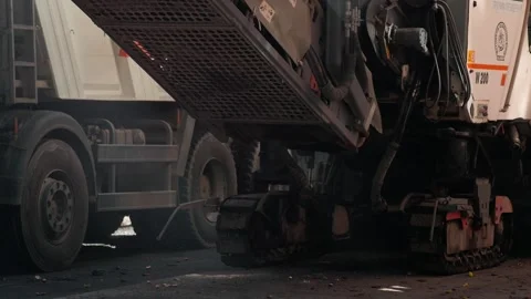 Road cold milling machine removes old asphalt loading it into dump truck. 스톡 동영상 248050529