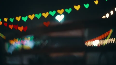 Road colorful lights blurred in the shape of a heart and a car passing by Stock Footage 231498756