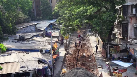 Road construction activities on the Postal Colony road in Mumbai, India. Stock Footage 307714432