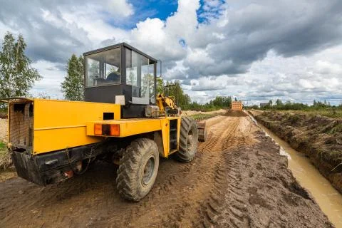 Road Construction and one of the construction machinery - bulldozer is Stock Photos
