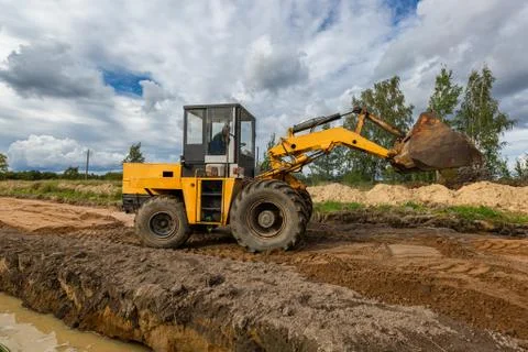 Road Construction and one of the construction machinery - bulldozer is Stock Photos