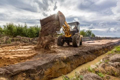 Road Construction and one of the construction machinery - bulldozer is Stock Photos