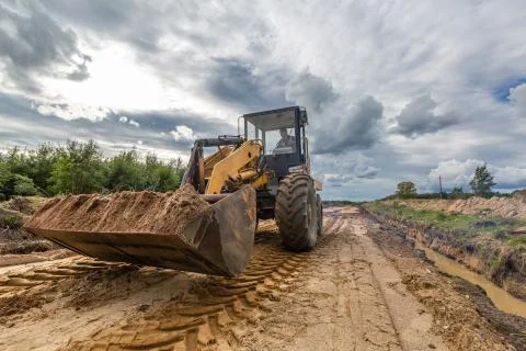 Road Construction and one of the construction machinery - bulldozer is Stock Photos