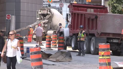 Road construction and pedestrian traffic on dusty hot summer day in the city Stock Footage