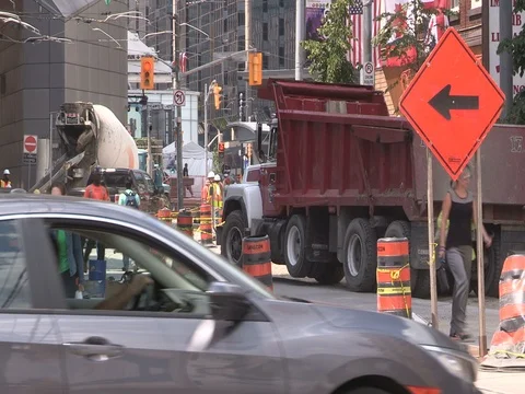 Road construction and pedestrian traffic on dusty hot summer day in the city Stock Footage