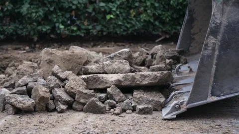 Road construction cleanup using heavy machinery in urban area. A close-up vie Stock Footage 293628568