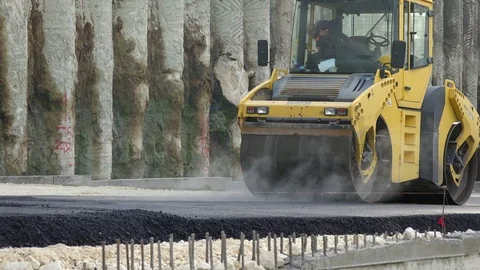 Road Construction. Compactor roller at asphalting work Stock Footage 97704054
