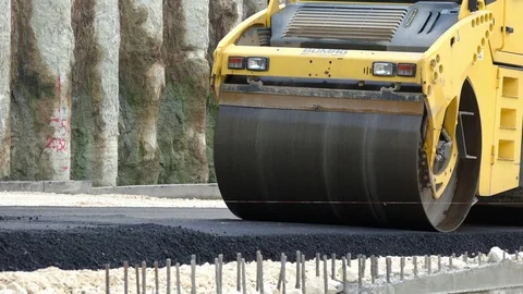 Road Construction. Compactor roller at asphalting work Stock Footage 97704175