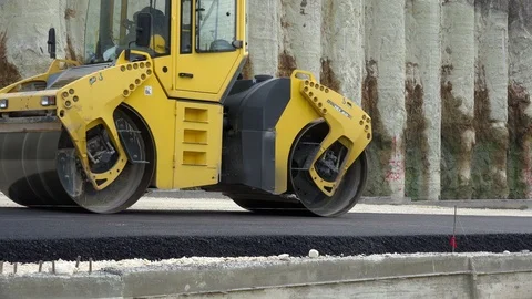 Road Construction. Compactor roller at asphalting work Stock Footage 97705311