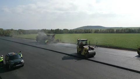 Road construction crew paving new asphalt road. Clip Stock Footage 312073861