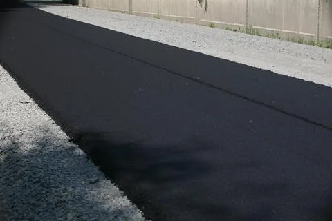 Road Construction Crew Paving a New Asphalt Surface Stock Photos