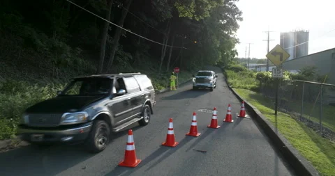 Road Construction Flagger Directing Traffic Along Road Holding Slow / Stop Sign Vídeo Stock 201281930