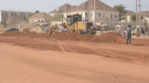 Road construction grader leveling dirt surface during infrastructure development 動画素材 325853477