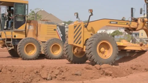 Road construction grader leveling dirt surface during infrastructure development 動画素材 325853487