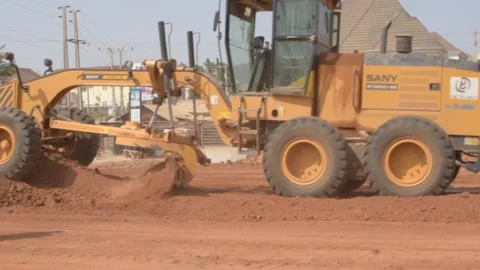 Road construction grader leveling dirt surface during infrastructure development 動画素材 325853496