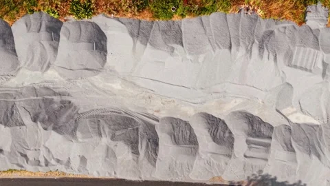 Road construction materials. Crushed stone aggregate stockpiles along roadside Stock Footage 340553860