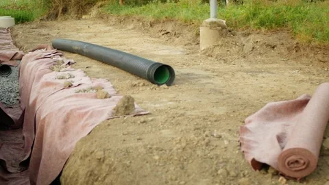 Road construction new sewer pipe drainage installation roadway roadwork trench 스톡 동영상 346527328