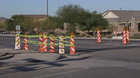 Road construction pylons with caution tape, cars pass by Stock Footage 45515701