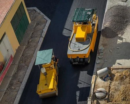 Road construction with roller compactor machine Stock Photos