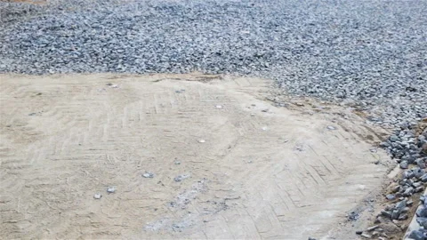Road construction: sand and rubble scattered on the future roadway. Real time, G Stock Footage 109063725