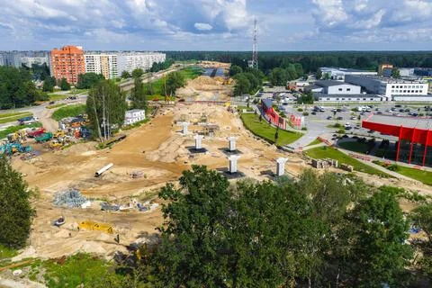 Road Construction Site with Bridge Pillars and Heavy Machinery in Latvia Stockfoto's