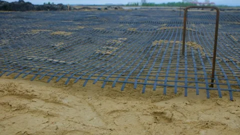 Road construction site preparing asphalt with metal grid and sand Stock Footage 311940395