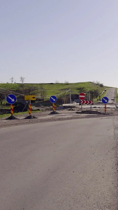 Road construction site with traffic barriers and warning signs indicating detour Stock Footage 325201907