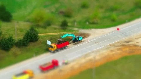 Road construction, tilt shift effect, trucks and excavator, road work, street Stock Footage 307514366