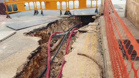 Road Construction Trench with Exposed Cables and Fences Stock Footage 304254937