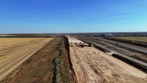 Road construction with trucks and rollers on a sunny day Stock Footage 320824493