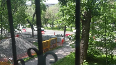 Road construction viewed through window bars on sunny day 스톡 동영상 308940717