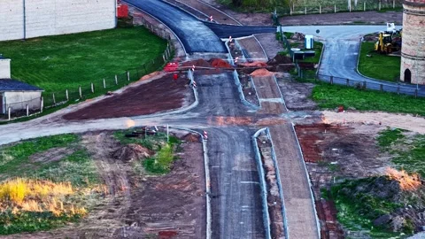Road construction work showing a new intersection being built and asphalt paving Stock Footage 346596284