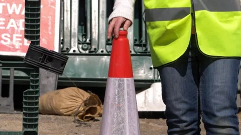 Road construction worker moving cones at road works site Stock Footage 152704891
