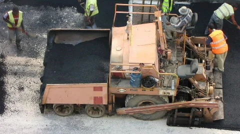 Road construction workers paving Stock Footage 572393