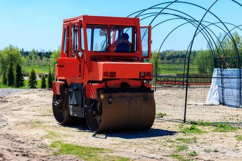 Road construction works with roller compactor machine Stock Photos