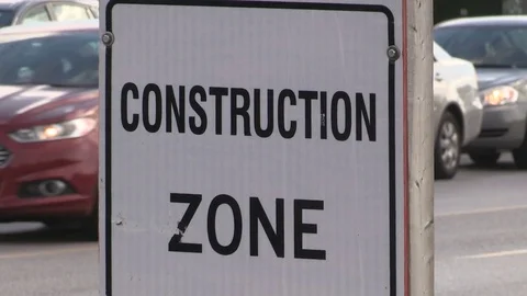 Road construction zone in heavy rush hour gridlock traffic jam with cars Stock Footage 77632716