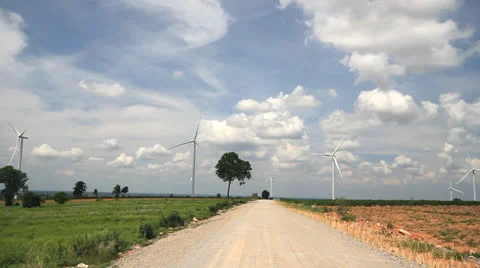 Road in countryside with wind turbines generating electricity Stock Footage 24956033