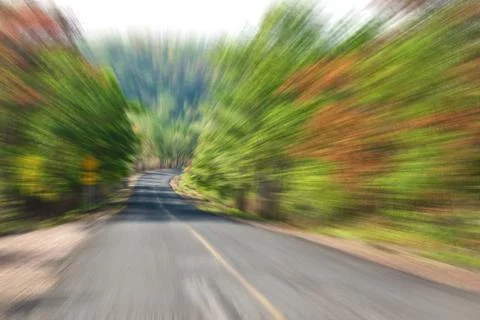 Road in Countryside with zoom blur technique used for high speed motion conce Stock Photos
