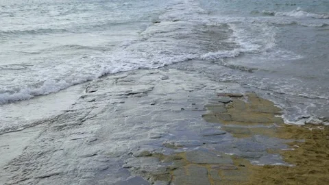 A road is covered with water as the tide rises in the ocean Stock Footage 199003692