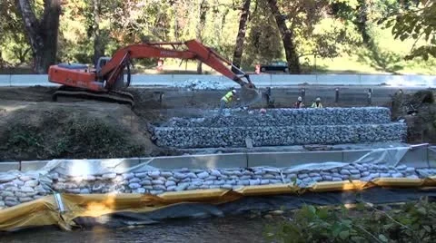 Road crew builds retaining wall, road repair. Video stock 8962578