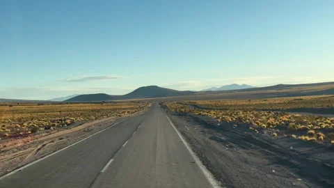 A road cuts through the salt flat of Salinas Grandes Stock Footage 312986564