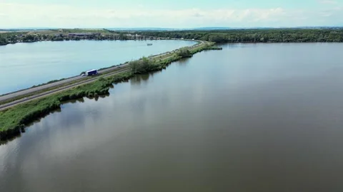 Road Cutting Through Lake in Czech Republic. Tranquil Scene with Cars and Buses Stock Footage 270760994