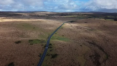 Road cutting through rugged Dartmoor Stock Footage 328631350